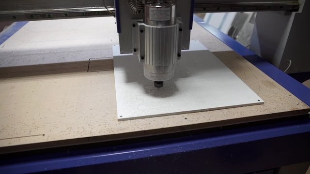 Milling cutting machine makes a plotter cutting in plastic currency signs
