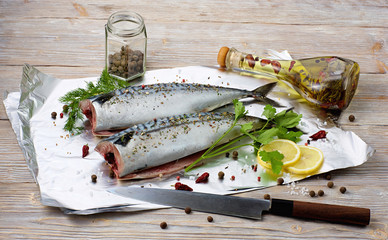 Fresh mackerel in foil with vegetable oil and spices. Stillife seafood.