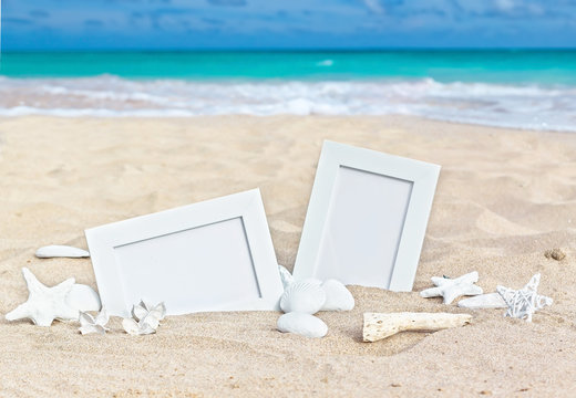 Seascape with two photo frames on the beach sand