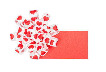 Card with bow from ribbon hearts for St. Valentine's Day isolated on the white