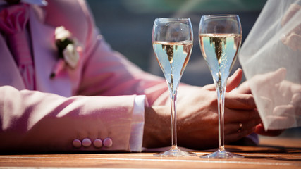 Couple, man and woman, drinking champagne in a fine dining restaurant, each with glass of sparkling wine in hand