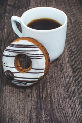 Cup of coffee and fresh donut