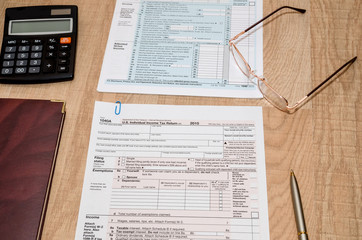 1040 Tax Form with calculator and pen