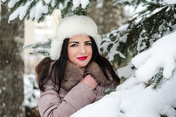 Portrait of young woman in winter park