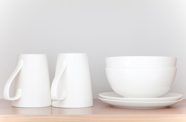 White coffee cup and white bowl in kitchen cabinet