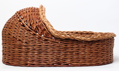 Obraz premium Basket for the baby. / Wicker basket for the child on a white background.