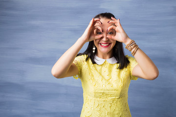Woman pretending that she is looking through binoculars 