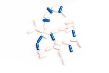 White and blue medical pills for treating diseases on a white background