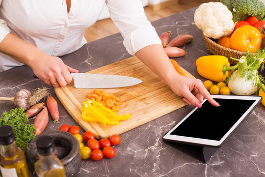 Woman using tablet for cooking 