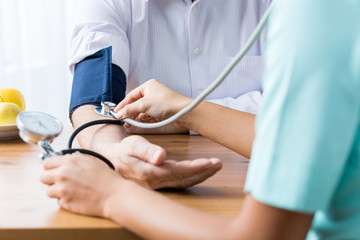 Doctor taking blood pressure