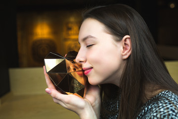 girl holding a heart.heart hands. a heart of gold in the hands of a young girl
