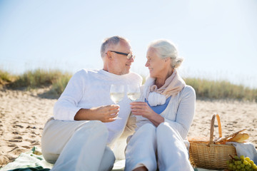 Fototapeta na wymiar happy senior couple talking on summer beach