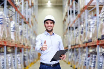 happy man at warehouse showing thumbs up gesture