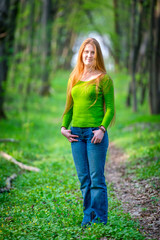Fototapeta premium Pretty woman with red hair in the park