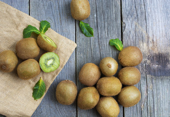 Juicy kiwi fruit on wooden background,