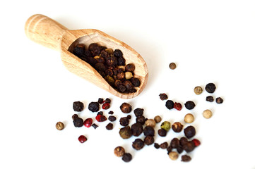 Black, red and white pepper on light background