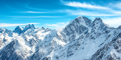 Fototapeta premium Panorama of white mountains in snow