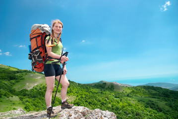 Naklejka na ściany i meble Hiking woman with backpack