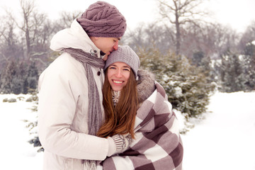 Obraz premium Happy couple in love in park in winter