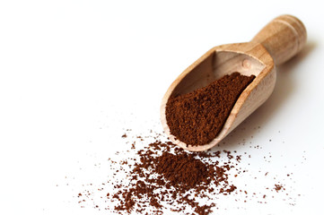 Ground coffee in wooden scoop