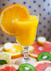  Freshly squeezed orange juice sitting on a rustic wooden table.