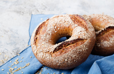 Wholegrain rye bread with seeds on blue napkin background Copy space