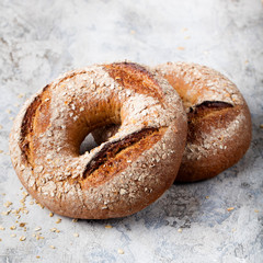 Wholegrain rye bread with seeds on stone grey background Copy space