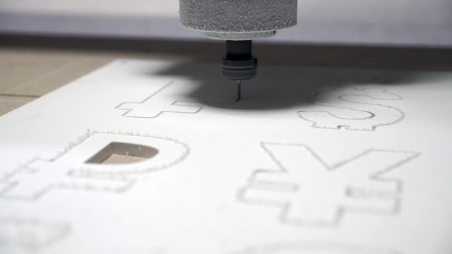 Milling cutting machine makes a plotter cutting in plastic currency FRANK signs