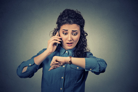 Time Management Concept. Stressed Businesswoman Looking At Wrist Watch, Running Late