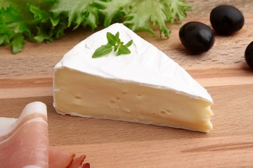 Cheese and ham on wooden platter