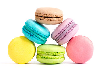 Collection of brightly colored French macarons on white background