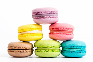 Collection of brightly colored French macarons on white background