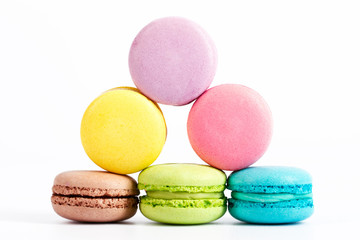 Collection of brightly colored French macarons on white background