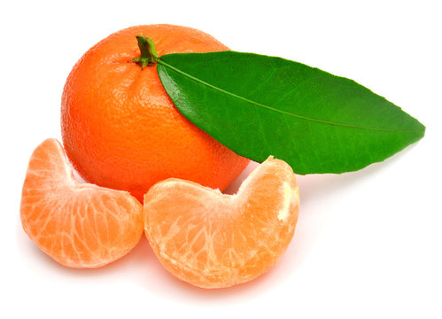 Mandarin with leaf and slices of peeled tangerine