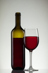 Wine in glass and bottle of wine on white