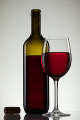 Wine in glass and bottle of wine on white