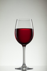 Wine in glass and bottle of wine on white