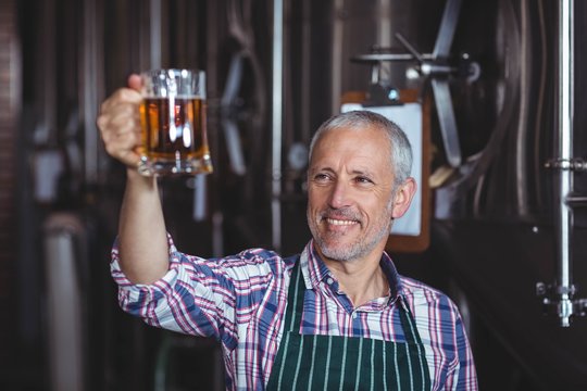 Happy brewer working in the plant