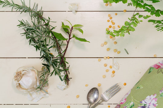 garlic and herbs on a cream background