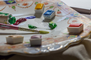 paint brushes, paint and paper