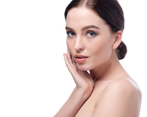 Obraz na płótnie Canvas Beauty Woman Face closeup. Beautiful brunette young spa model girl with perfect skin. Skin care concept. Fresh Clean Skin. Portrait of female looking at camera and smiling. Beige background