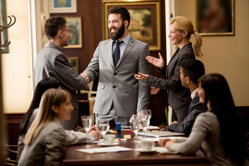 group of smiling business people or lawyers - meeting in an offi