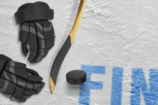 Finnish stick, gloves and puck on ice