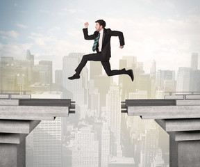 Energetic business man jumping over a bridge with gap