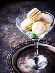 Macaroons in a glass on a high leg.