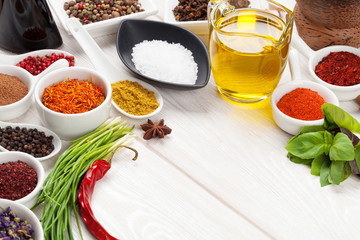 Various spices on white wooden background