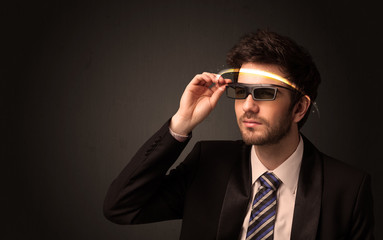 Handsome man looking with futuristic high tech glasses