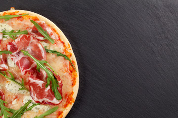 Pizza with prosciutto and mozzarella