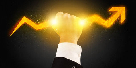 Business person holding a hot glowing upright arrow