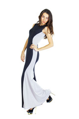 Portrait in full growth of a young woman in long evening dress